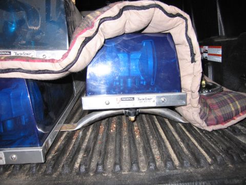 1991 Ford LTD Crown Victoria - Two Federal Twin Sonic blue emergency beacon lights sit in a pickup bed, one partly covered by a packing blanket.