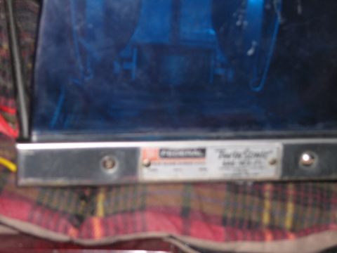 1991 Ford LTD Crown Victoria - Close-up of a blue Federal Twin Sonic emergency beacon showing its silver base and red-and-white maker label.
