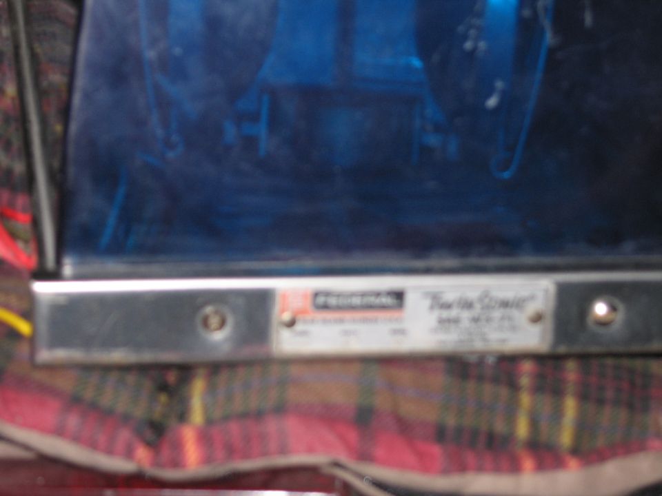 Close-up of a Federal Twin Sonic label on a blue emergency beacon light