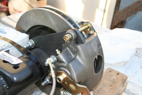 1992 Ford Bronco - Close-up of a rear disc brake caliper and rotor assembly, with packaging and part numbers visible.