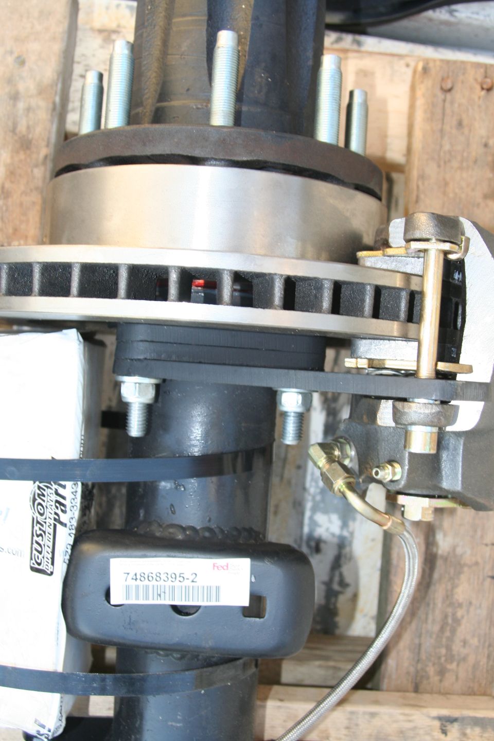 Close-up of a rear axle disc brake assembly with part number 74868395-2 visible