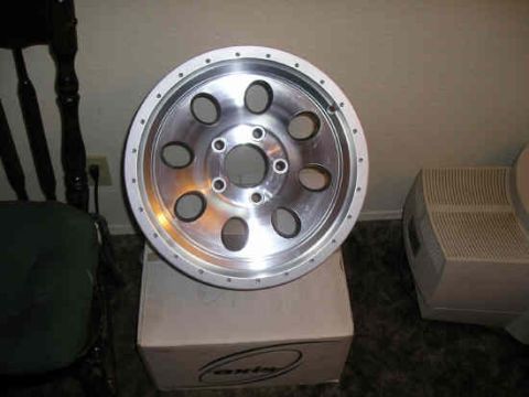 2002 Ford F-150 - Aftermarket aluminum wheel shown on top of a cardboard box.