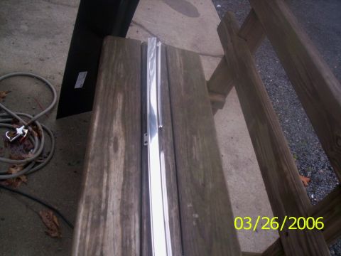 1988 Ford Bronco - A chrome trim piece is shown on a wooden surface, with a date stamp indicating March 26, 2006.