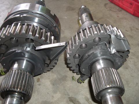 1989 Ford Bronco - Comparison of transfer case components, highlighting damage on one part.
