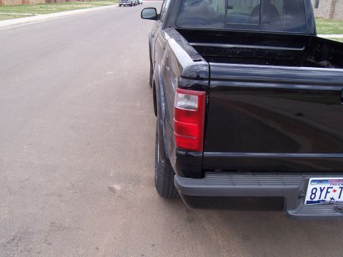 2003 Ford Ranger - Rear view of a black 2003 Ford Ranger pickup truck parked on a residential street.