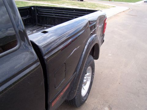 2003 Ford Ranger - Side view of a black Ford Ranger pickup truck bed with an 'EDGE' decal.