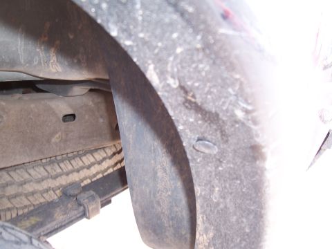 2003 Ford Ranger - This image shows the underside of a vehicle, focusing on the rear wheel well and suspension components.