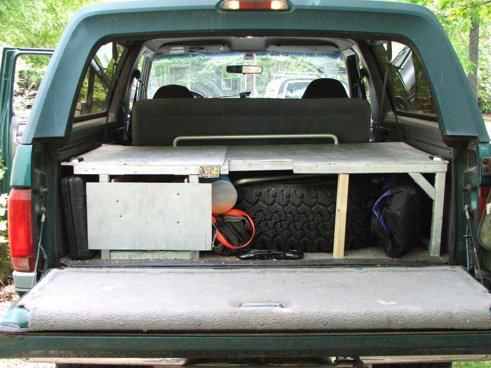 1996 Ford Bronco rear storage with spare tire, camping bags, and custom platform
