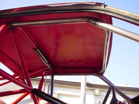 1968 Ford Torino - A close-up view of a red roll cage structure inside a vehicle.