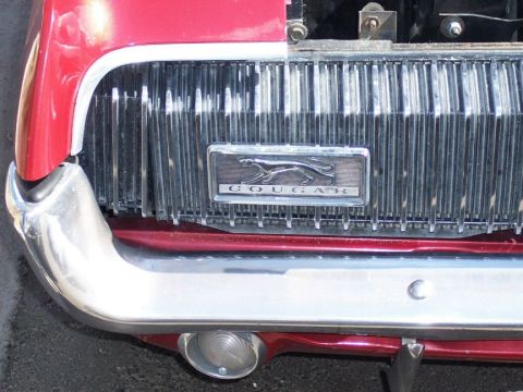 1972 Ford Ranchero - Front view of a red 1969 Cougar, its distinctive grille and chrome bumper.