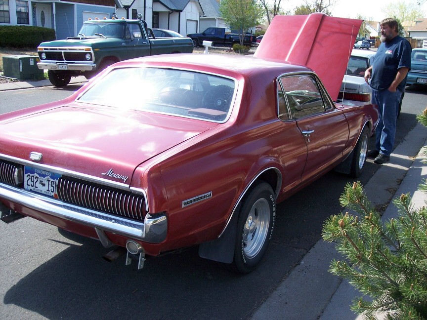 Red 1969 Mercury Cougar XR7 rear view with hood open