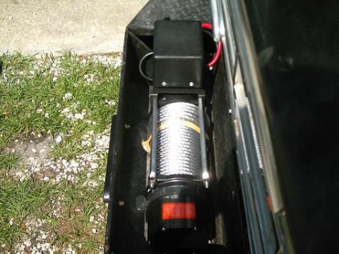 1986 Ford Bronco - A winch assembly is installed in a vehicle's bumper area.