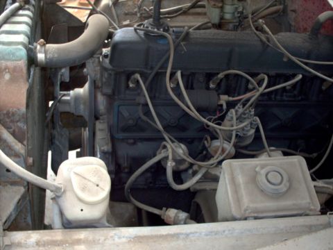 1965 Ford F-100 - Close-up view of an engine bay, showing various components and wiring.