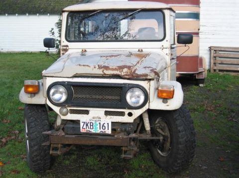 1991 Ford Explorer - This Toyota Land Cruiser FJ40 shows significant rust and wear, parked outdoors with a trailer.
