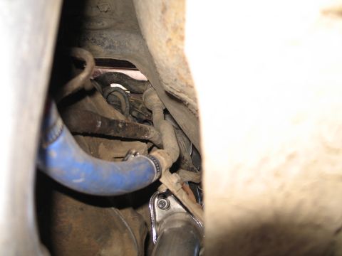 1995 Ford Bronco - Underside view of a vehicle's mechanical components, including a blue hose and exhaust system.