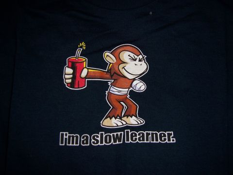 1983 Ford Bronco - Cartoon monkey holding dynamite with text 'I'm a slow learner.' on a dark background.