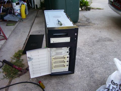 1994 Ford Probe - Computer tower with open front panel and tools scattered around on a concrete surface.