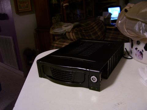 1994 Ford Probe - A black computer hard drive enclosure sits on a table, with a couch and TV in the background.