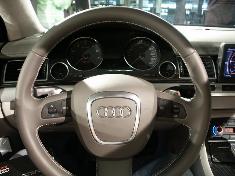 Audi steering wheel with four rings logo and dashboard gauges