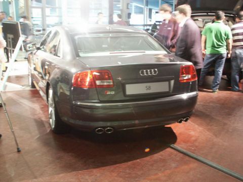 2001 Mercury Grand Marquis - Rear view of an Audi S8 sedan with quad exhaust pipes and S8 badging, seen indoors.