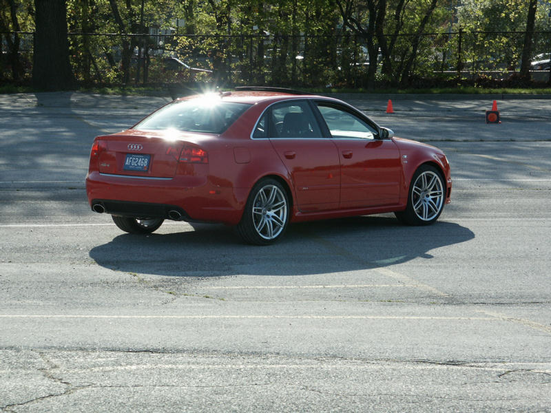 Red Audi sedan, rear 3/4 view, with license plate AFG2468