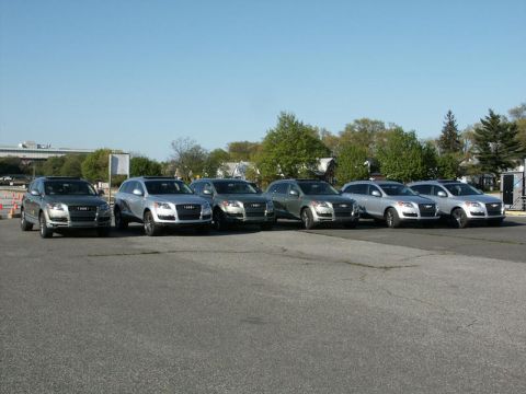 2001 Mercury Grand Marquis - Multiple Audi Q7 SUVs are lined up in a parking lot under a clear sky.
