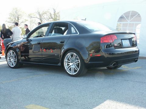 2001 Mercury Grand Marquis - A black Audi sedan is parked on asphalt with a white tent structure behind it.