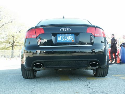 2001 Mercury Grand Marquis - The rear of a black Audi RS4 is shown with dual exhaust pipes and a Michigan license plate.