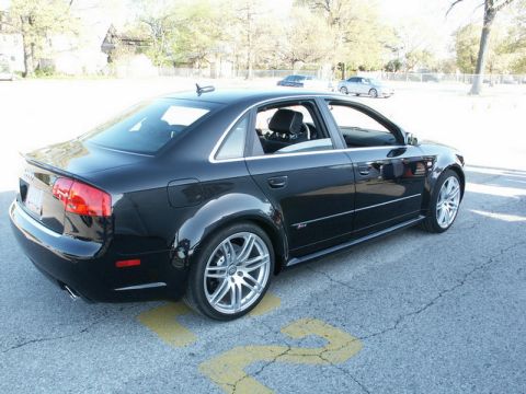 2001 Mercury Grand Marquis - A black Audi sedan is parked on asphalt with yellow markings. The vehicle has aftermarket wheels and a sporty appearance.