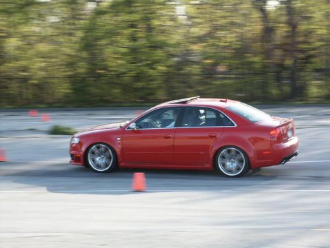 2001 Mercury Grand Marquis - A red sedan navigates a course marked by orange cones on a paved surface.