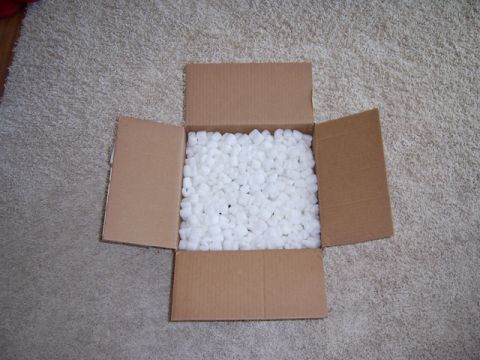 1996 Ford Bronco - A box of packing peanuts sits on a carpet, with the Supermotors logo visible.