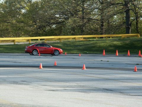 2001 Mercury Grand Marquis - A red sedan navigates a course marked by orange cones on a paved track.