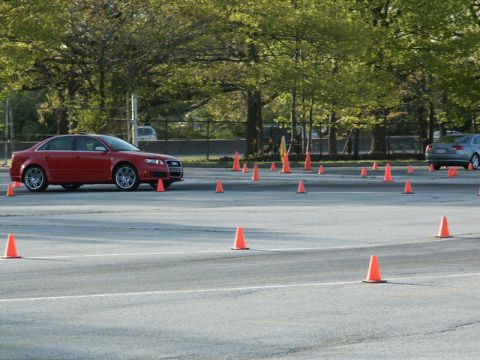 2001 Mercury Grand Marquis - Red Audi sedan on a cone course, with a silver sedan in the background.