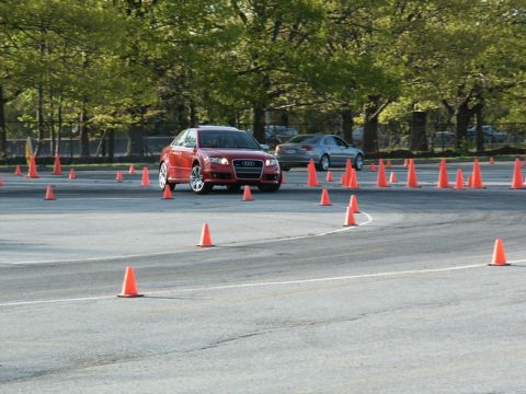 2001 Mercury Grand Marquis - An Audi A4 is driven through a course marked by orange cones, with another car visible in the background.