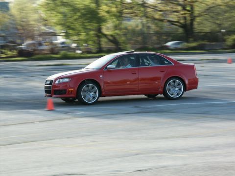 2001 Mercury Grand Marquis - A red Audi sedan navigates a course marked by orange cones on a paved surface.