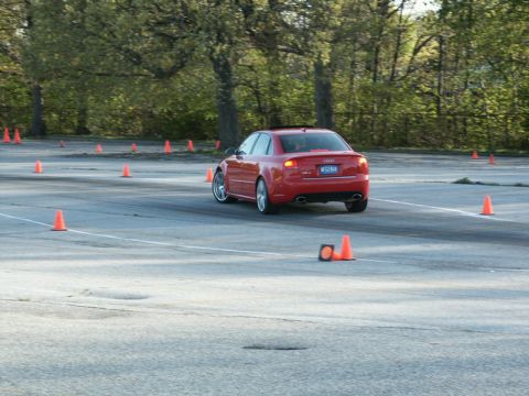 2001 Mercury Grand Marquis - Red Audi sedan navigates a cone course on a paved track.