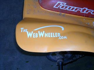 1968 Ford Mustang - Close-up of a yellow vehicle part showing "The WebWheeler.com" text.