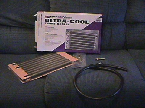 1994 Ford Bronco - A Hayden Ultra-Cool transmission cooler kit is displayed on a couch.