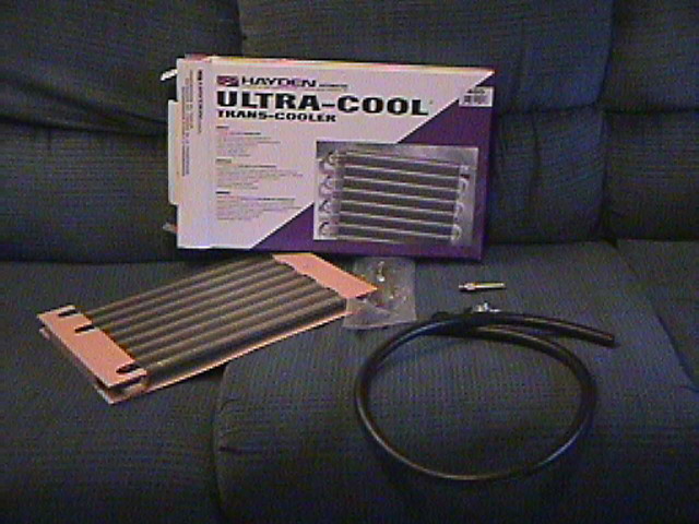 Hayden Ultra-Cool trans-cooler kit with core, box, hose and hardware on a couch