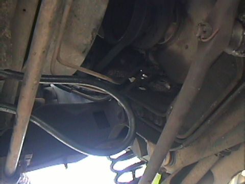 1994 Ford Bronco - Close-up of the undercarriage, showing suspension parts and exhaust system details.