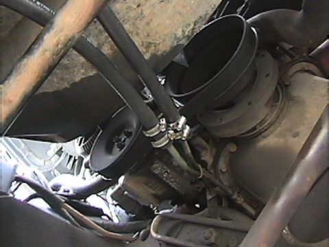 1994 Ford Bronco - Close-up view of transmission cooler lines and associated engine components.