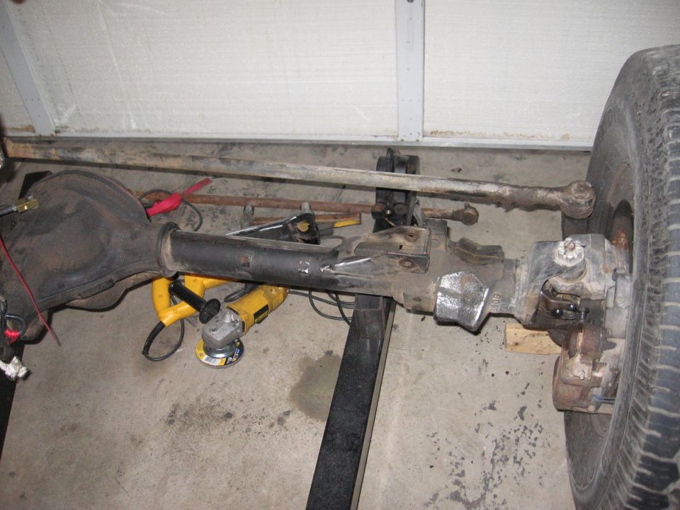 Front axle assembly with disc brake and tie rod, on jack stands