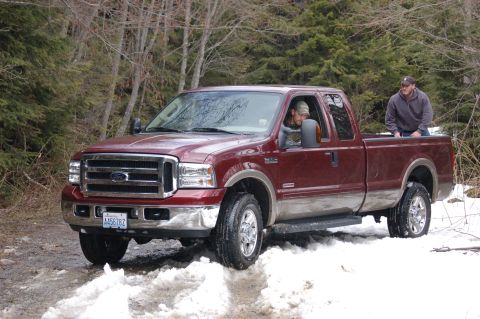 2006 Ford F-250 - Ford F-250 Super Duty truck navigates a snowy path through a wooded area.