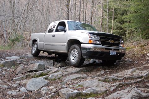 2006 Ford F-250 - Silver Chevrolet Silverado pickup truck on a rocky trail.
