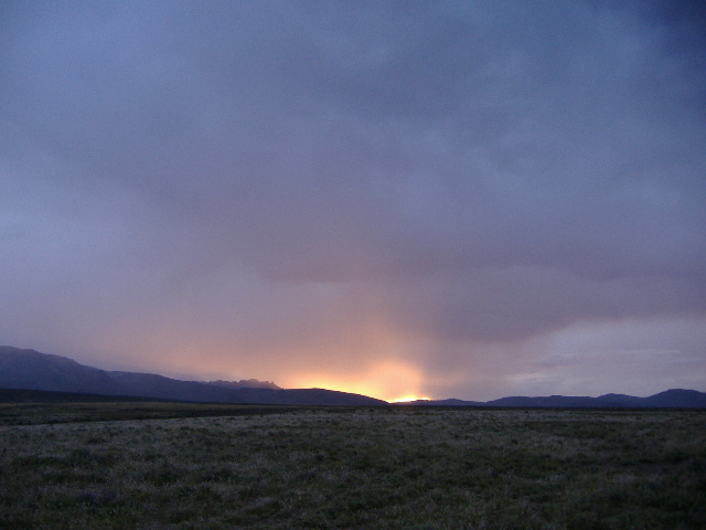 Landscape with mountains and a cloudy sunset sky