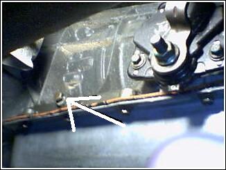 1995 Ford Bronco - Undercarriage detail with a metal bracket and wiring, the Supermotors.net logo.