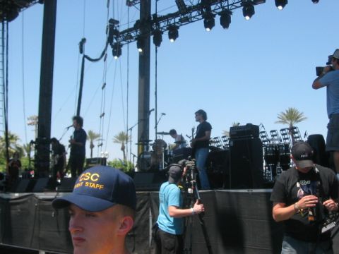 1991 Ford Bronco - A band performs on a large outdoor stage, with cameramen documenting the event.