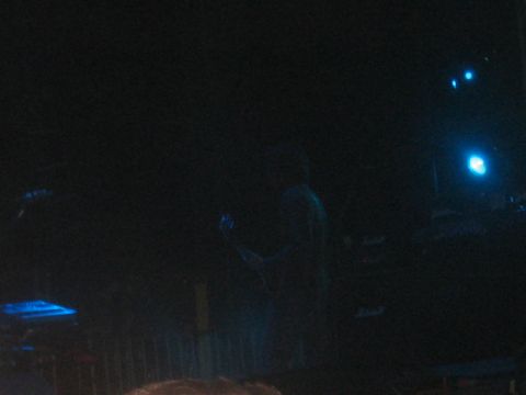 1991 Ford Bronco - A performer is on stage with blue lights illuminating the scene.
