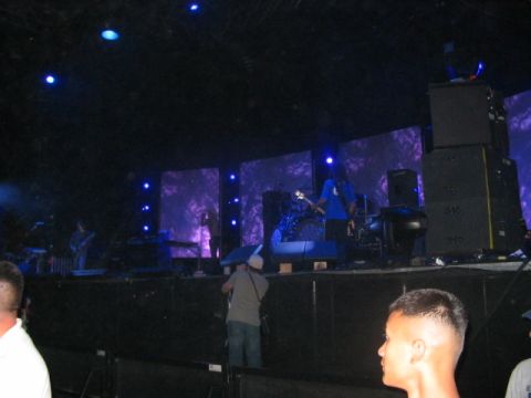 1991 Ford Bronco - A band plays music on a stage with large screens in the background.