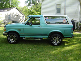 1994 Ford Bronco - This 1994 Ford Bronco is seen from the side, a teal body and white removable hardtop.